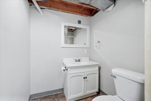 An additional half bathroom adds everyday functionality to the lower level.