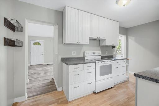 Crisp white cabinetry, generous storage and plenty of prep space make this kitchen as functional as it is bright.