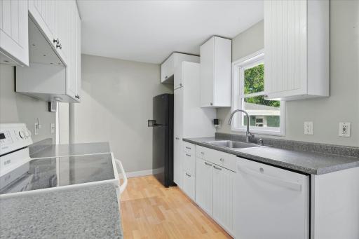 A window above the sink brings in natural light, while abundant cabinetry keeps everyday essentials within reach.