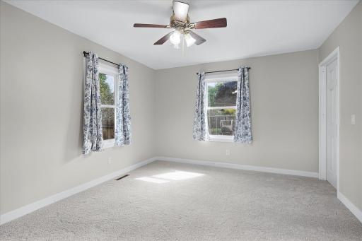 The spacious main-level primary features brand-new carpeting, a generous walk in closet and a walk-through bathroom.