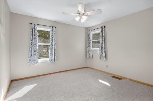 The second main-level bedroom offers great natural light and plenty of flexibility for guests, an office or additional bedroom space.