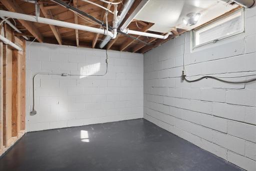 A clean, versatile unfinished space offering plenty of potential for storage, a workshop, home gym, or future finishing.