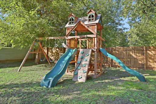 The existing playset creates a ready-to-enjoy outdoor space, all tucked inside the privacy of the fenced backyard.