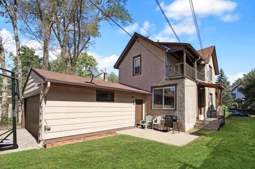 Attached garage with a patio area and covered side entrance.jpg