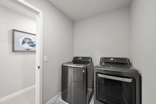 Upper-level laundry keeps everything close at hand, complete with an LG washer and dryer and nearby linen storage.