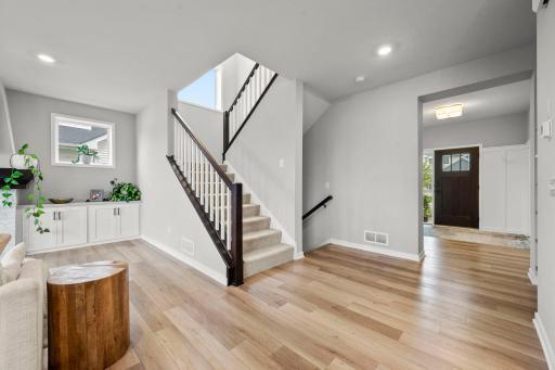 The spacious entry is finished with detailed wainscoting and opens into a bright, inviting main level with 9-ft ceilings and an easy flow from room to room.