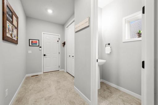 The mudroom keeps everyday life organized with dedicated storage, garage access, and a convenient half bath.