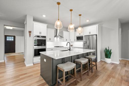 The kitchen is both beautiful and practical, with Frigidaire stainless steel appliances including double wall ovens.