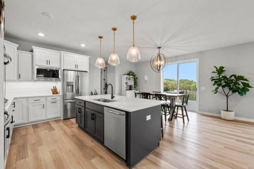 Tiled backsplash for added character, and oversized 8x5 walk-in pantry with shelving.