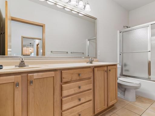 Private primary bath featuring an expansive vanity and generous storage.