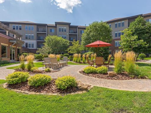 Gather with friends in the charming courtyard surrounded by colorful gardens.