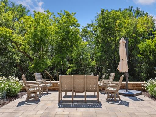 A private outdoor retreat surrounded by mature trees and lush landscaping.