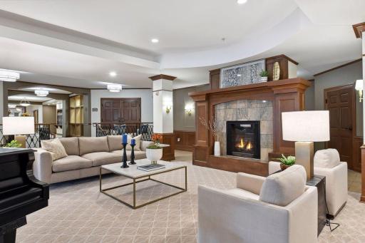 The lobby is an elegant gathering space featuring a grand piano and sophisticated architectural details.