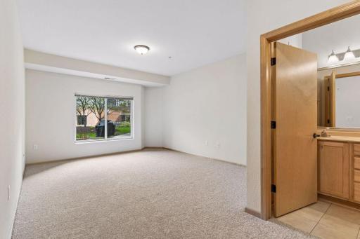 Comfortable primary suite with generous proportions and convenient private bath.