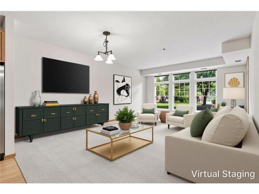 Light-filled living room with generous entertaining space and direct walkout access to your private screened patioâperfect for enjoying carefree, resort-style living. Virtually staged.