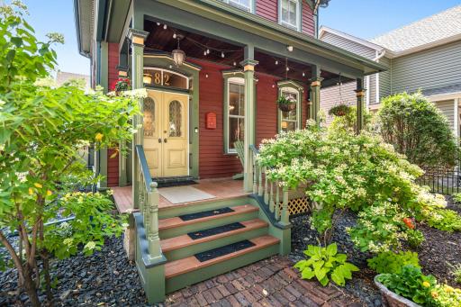 Greeted by a charming front porch, historic exterior colors and fresh landscaping.