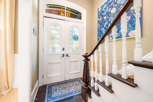 Step through the entryway to be greeted by a stunning staircase, soaring high ceilings and beautiful original woodwork details.