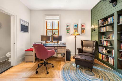 French doors lead into a freshly painted main level office with built-in book shelves and a powder bath.