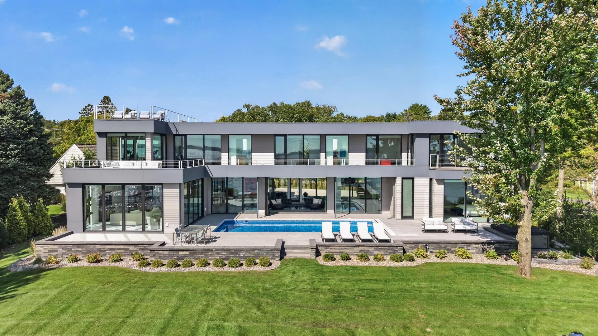 Elevated. Contemporary. Over 6,000 square feet of brand-new living on 120-ft of level shoreline along Browns Bay, set on iconic Shoreline Drive.