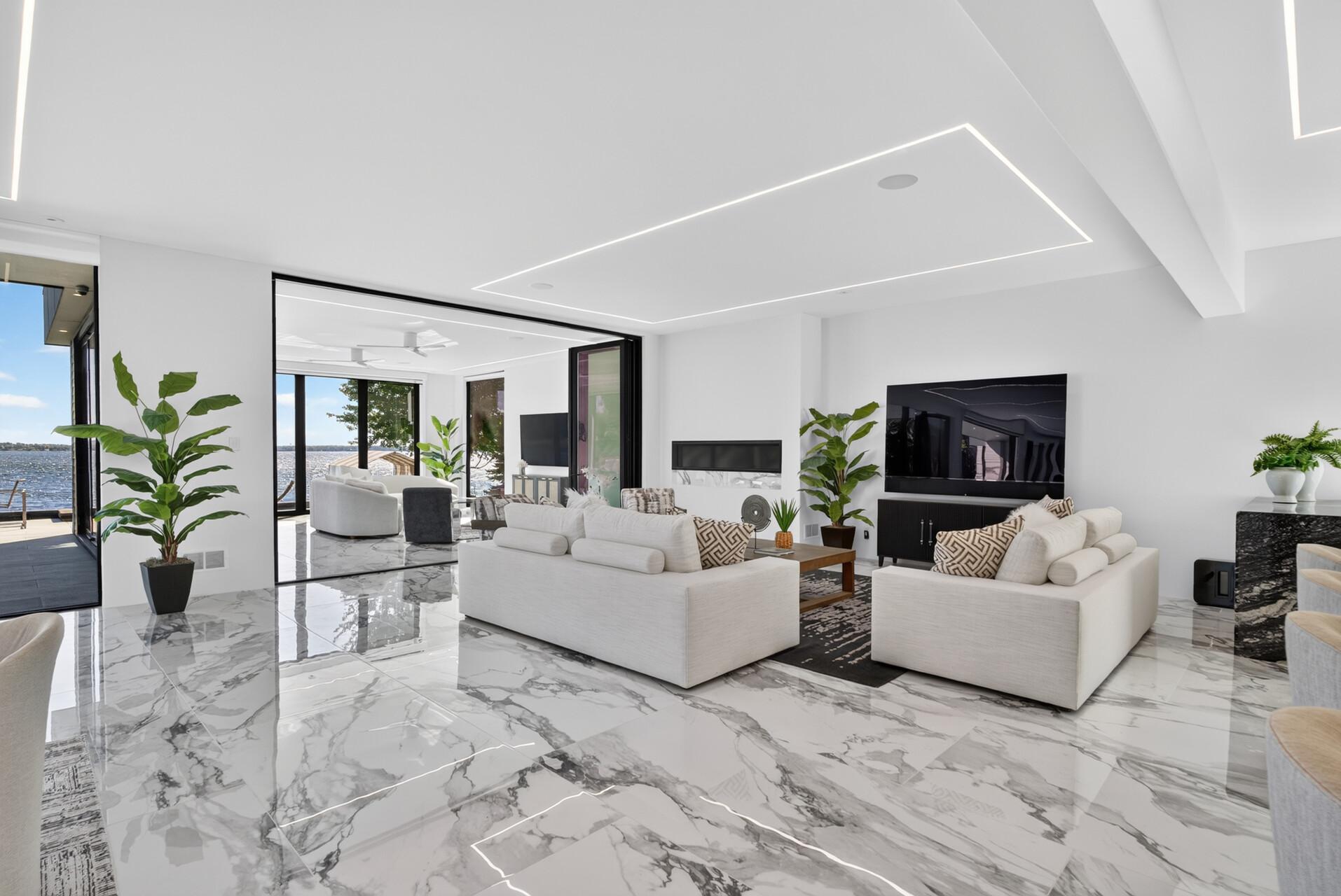 A dedicated counter seating area and electric fireplace add function and warmth without interrupting the clean, contemporary design.