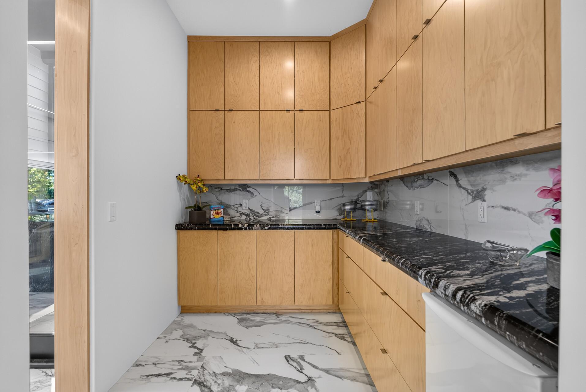 The walk-in pantry adds even more function with an ice maker and custom built-in organization from floor to ceiling.