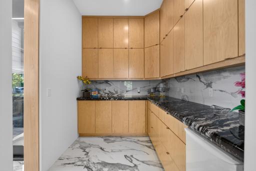 The walk-in pantry adds even more function with an ice maker and custom built-in organization from floor to ceiling.