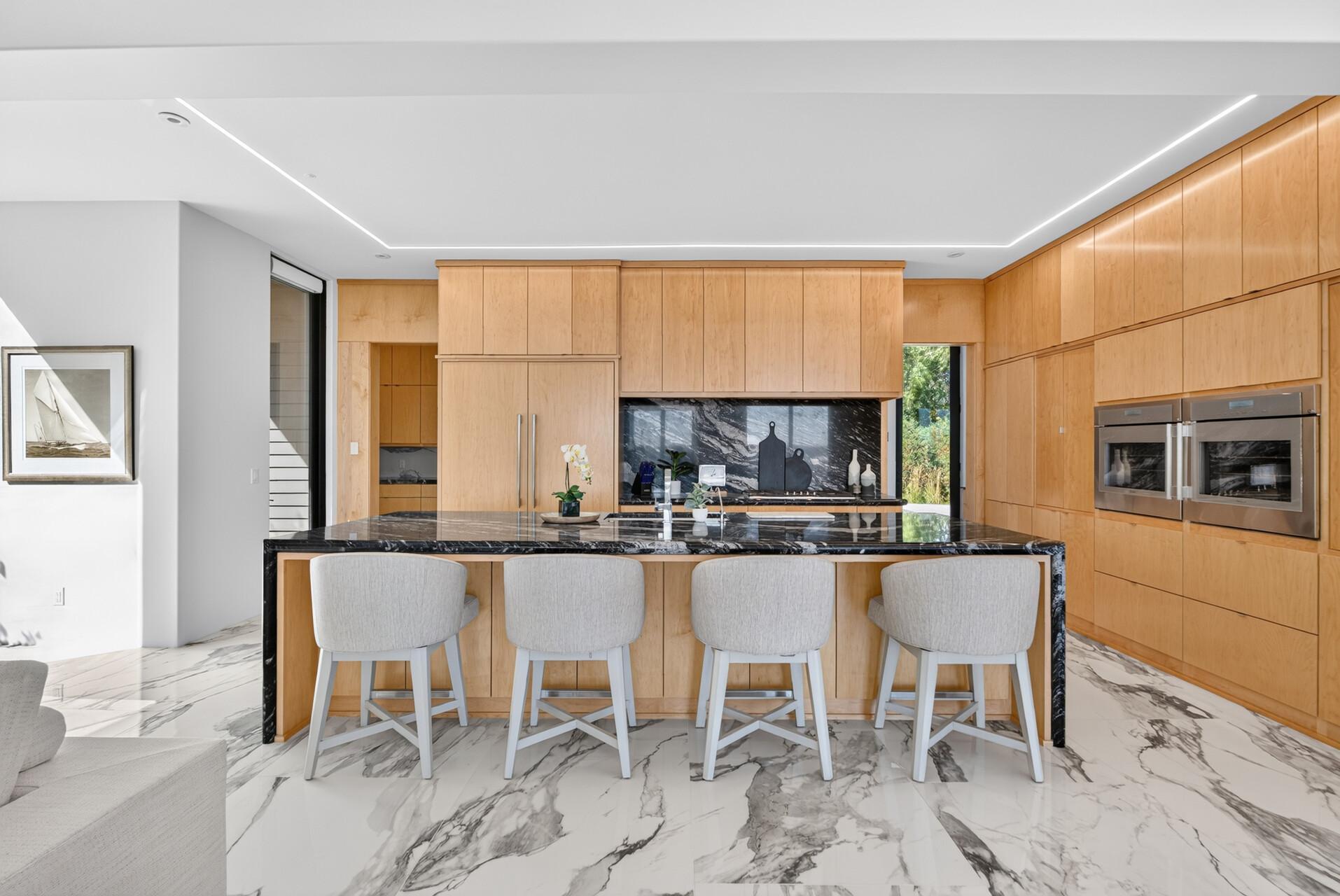 Pull-out shelving, soft-close drawers, and thoughtful organization are integrated throughout.