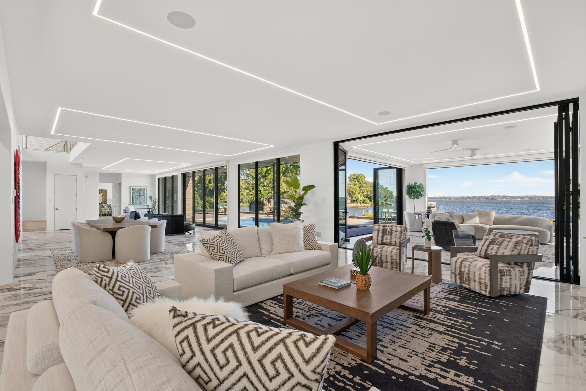 Floor-to-ceiling windows span the entire south side of the home, filling the interiors with natural light and uninterrupted lake views.