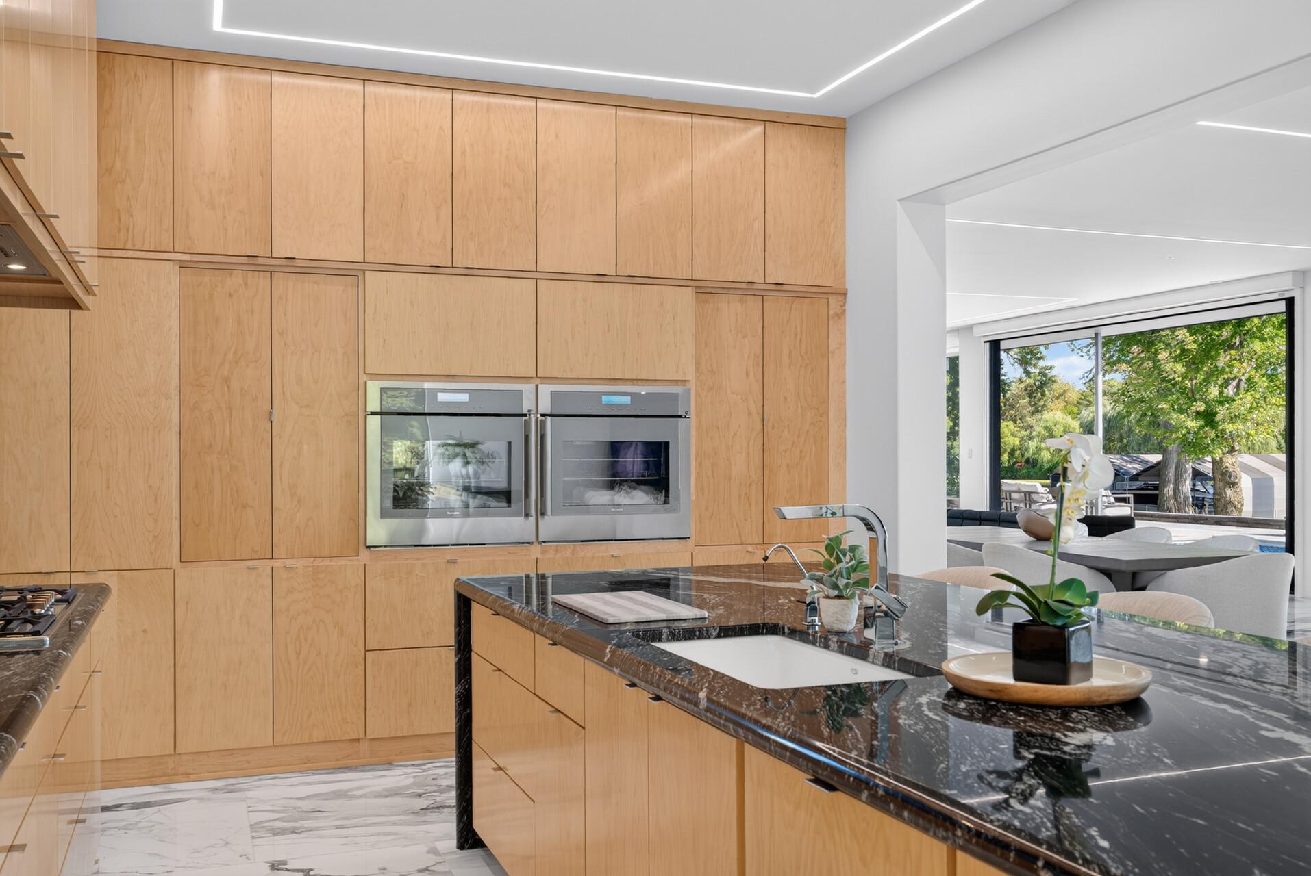 Finished with abundant inset cabinetry, high-end Thermador appliances, including double ovens.