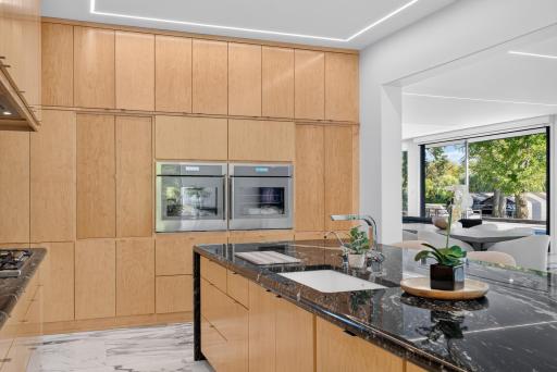 Finished with abundant inset cabinetry, high-end Thermador appliances, including double ovens.