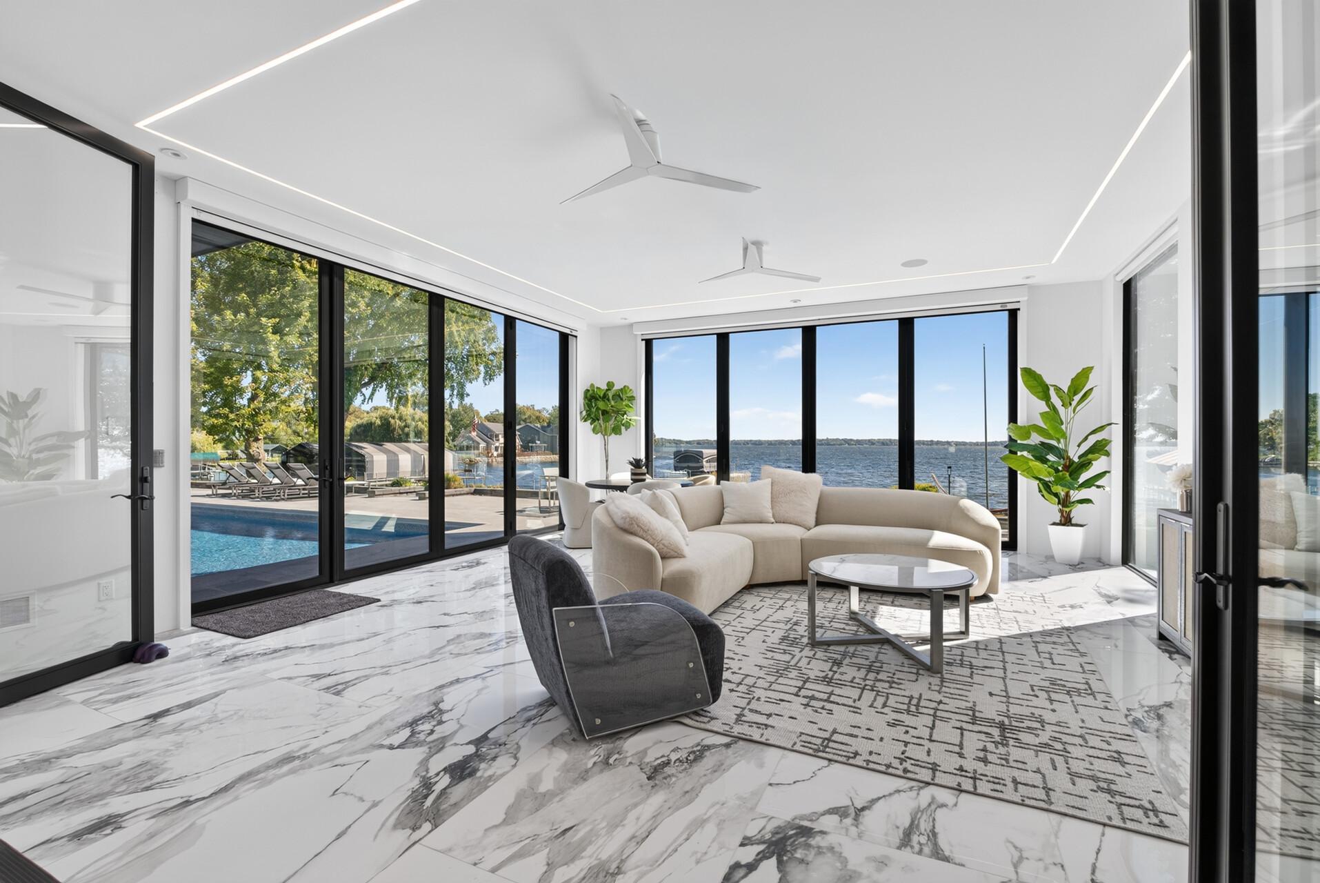 The main floor also includes a stunning sunroom surrounded entirely by floor-to-ceiling windows.