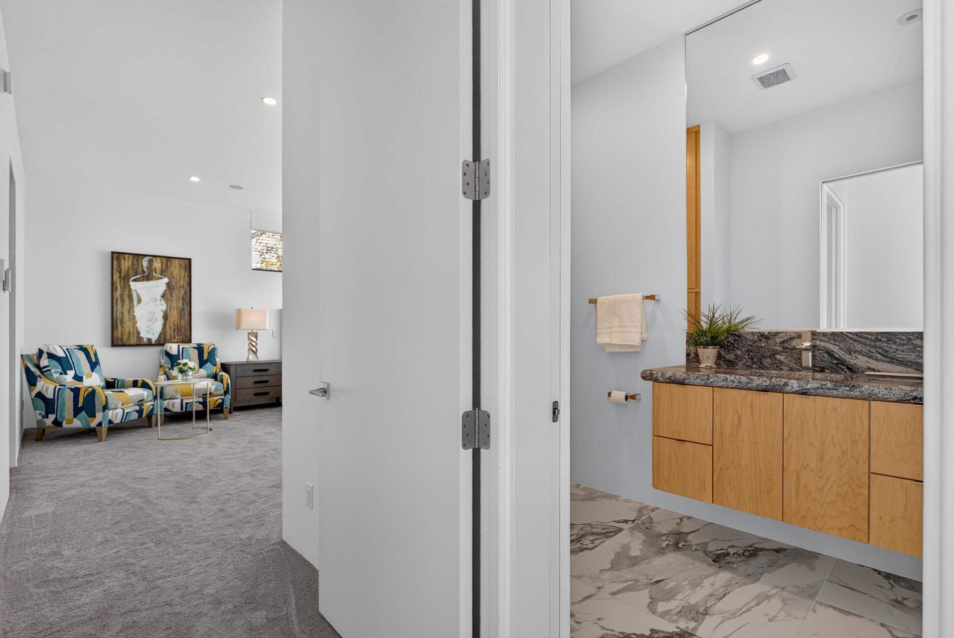 Even the powder room carries the same attention to design, with a contemporary floating vanity in a convenient location.