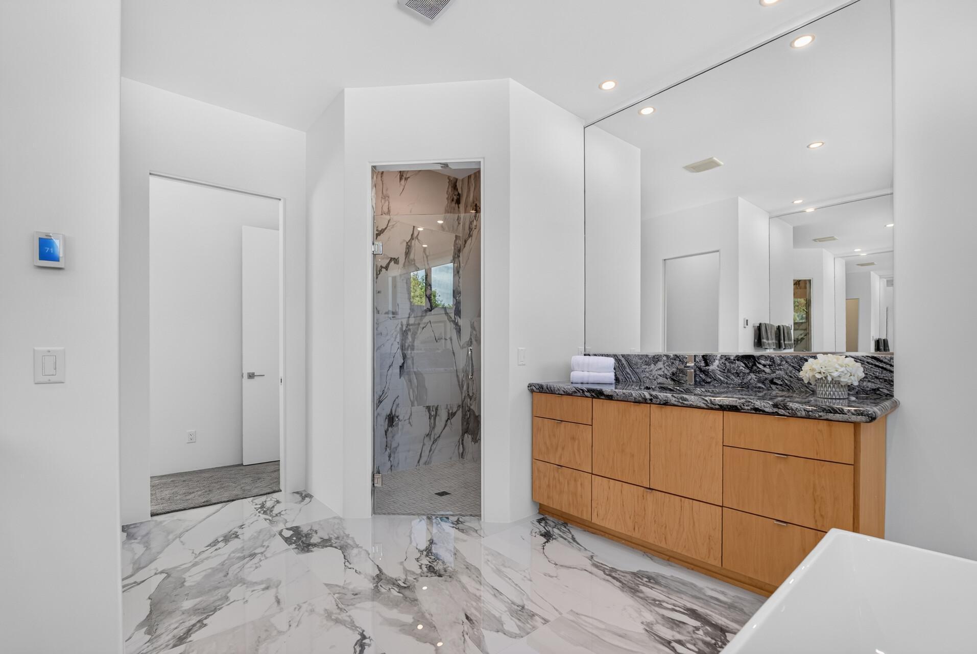 Large tiled walk-in shower with dual shower heads.