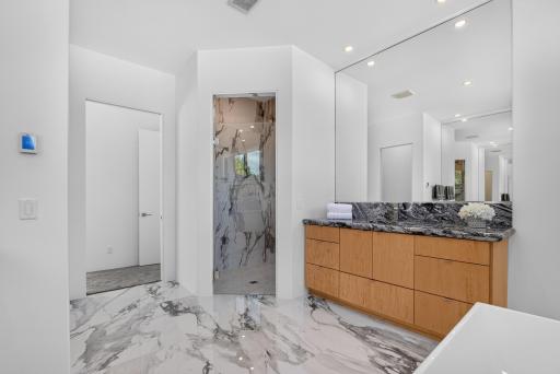 Large tiled walk-in shower with dual shower heads.