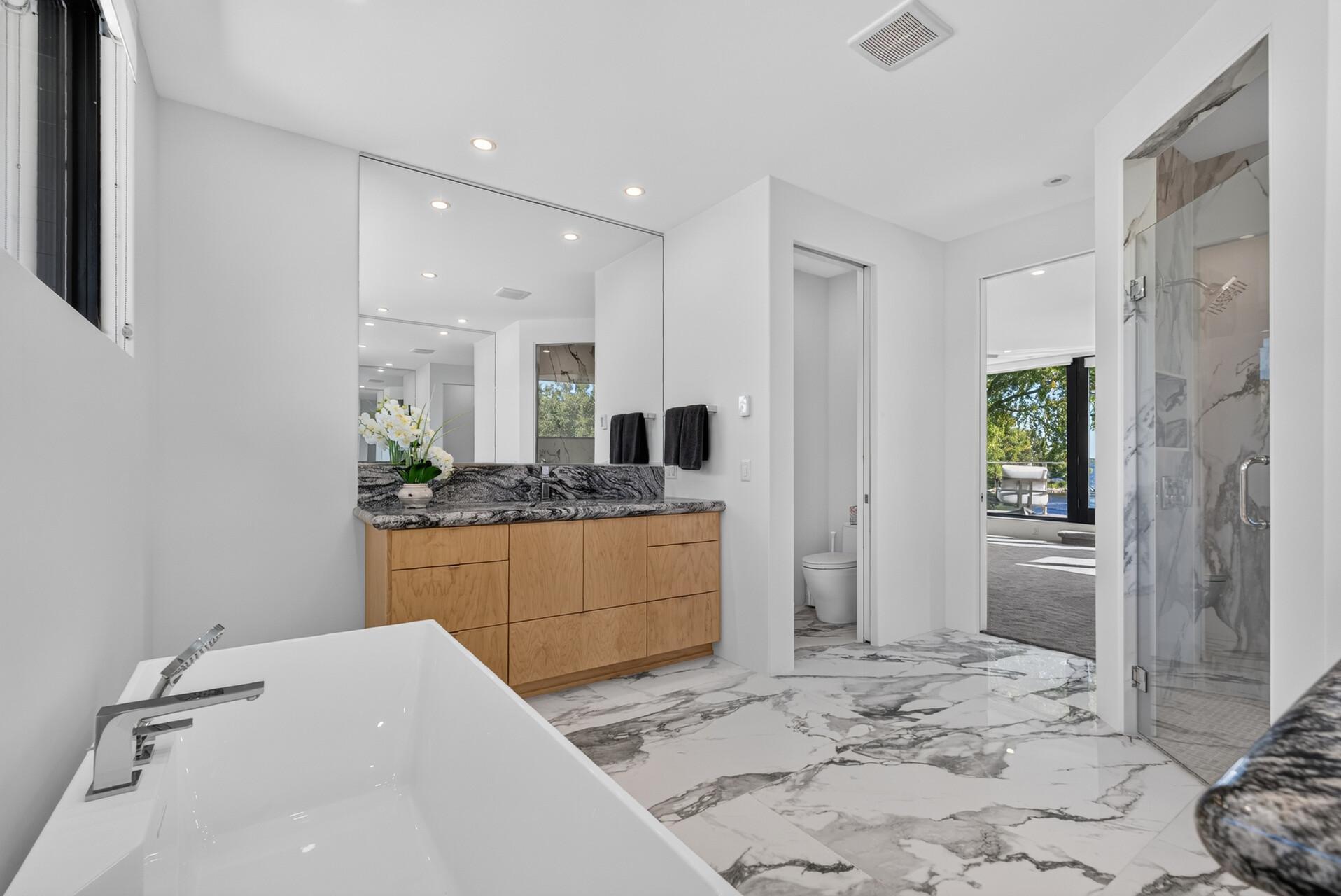 Large tiled walk-in shower and integrated towel warmer.