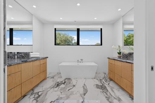 Beautiful ensuite with two separate vanities and a freestanding tub.