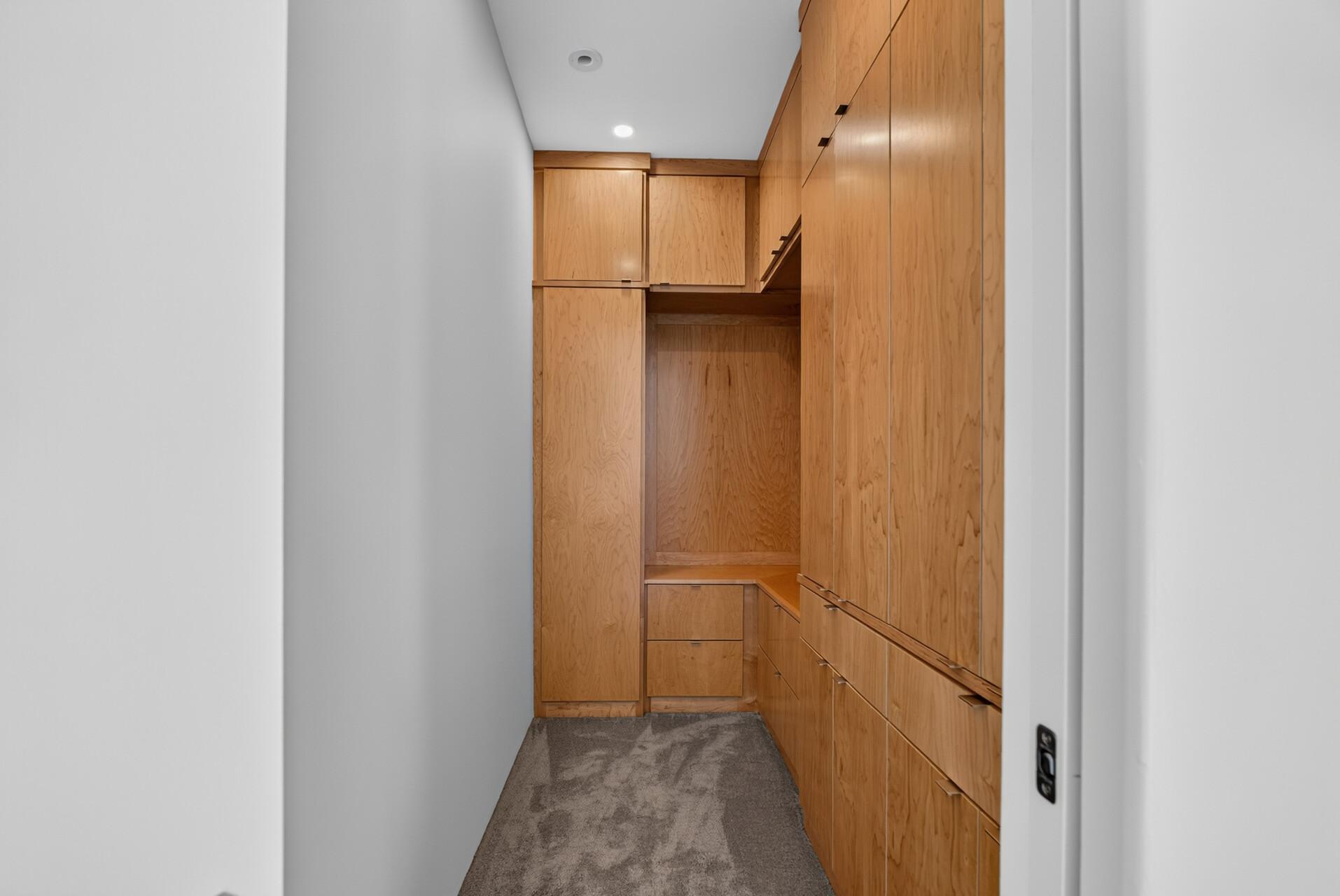 Each bedroom has its own walk-in closet with floor-to-ceiling custom organization. (Closet - Upper-level bedroom #2)