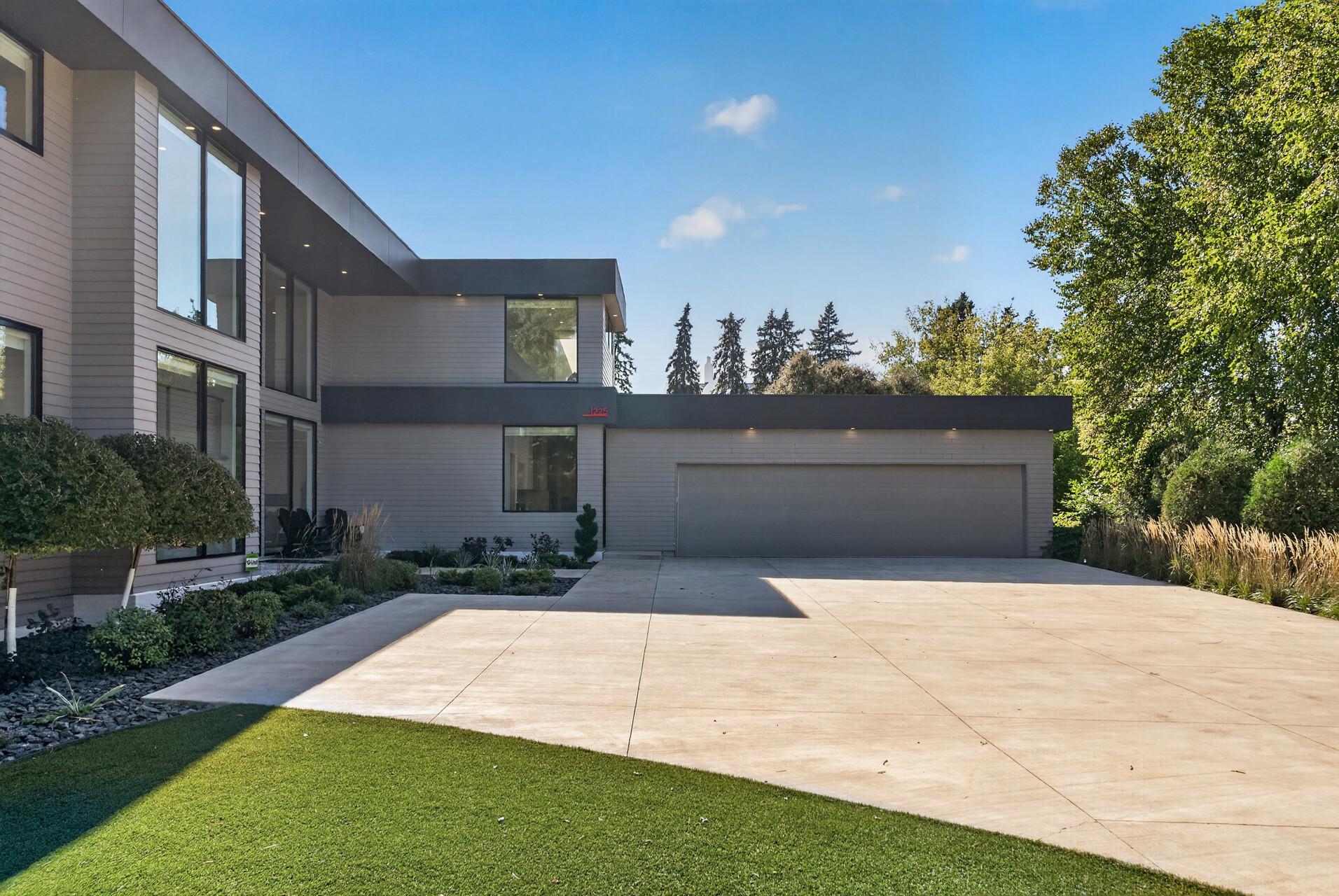 A finished, heated three-car attached garage adds even more function with custom flooring, workbench, and storage.
