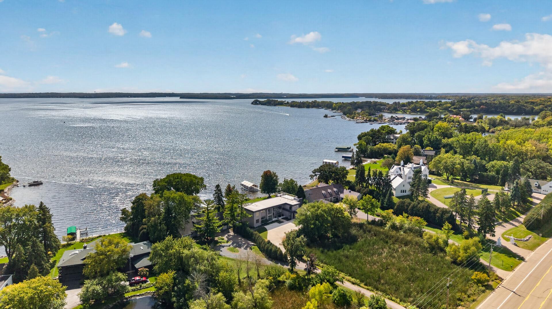 The level, over-an-acre setting sits back from the road, offering exceptional privacy, generous outdoor space, and direct access to Browns Bay.