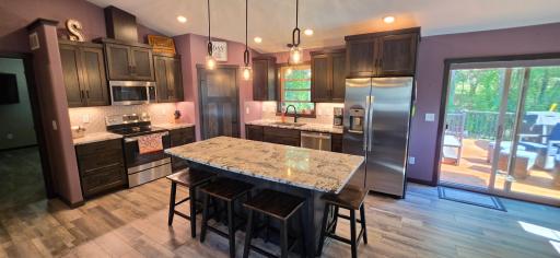 Large center island with granite top will accommodate most meals!