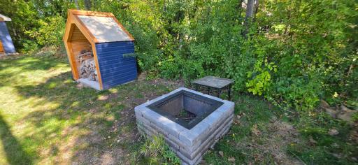 Smokeless fire pit in back along with a nice wood pile cover!