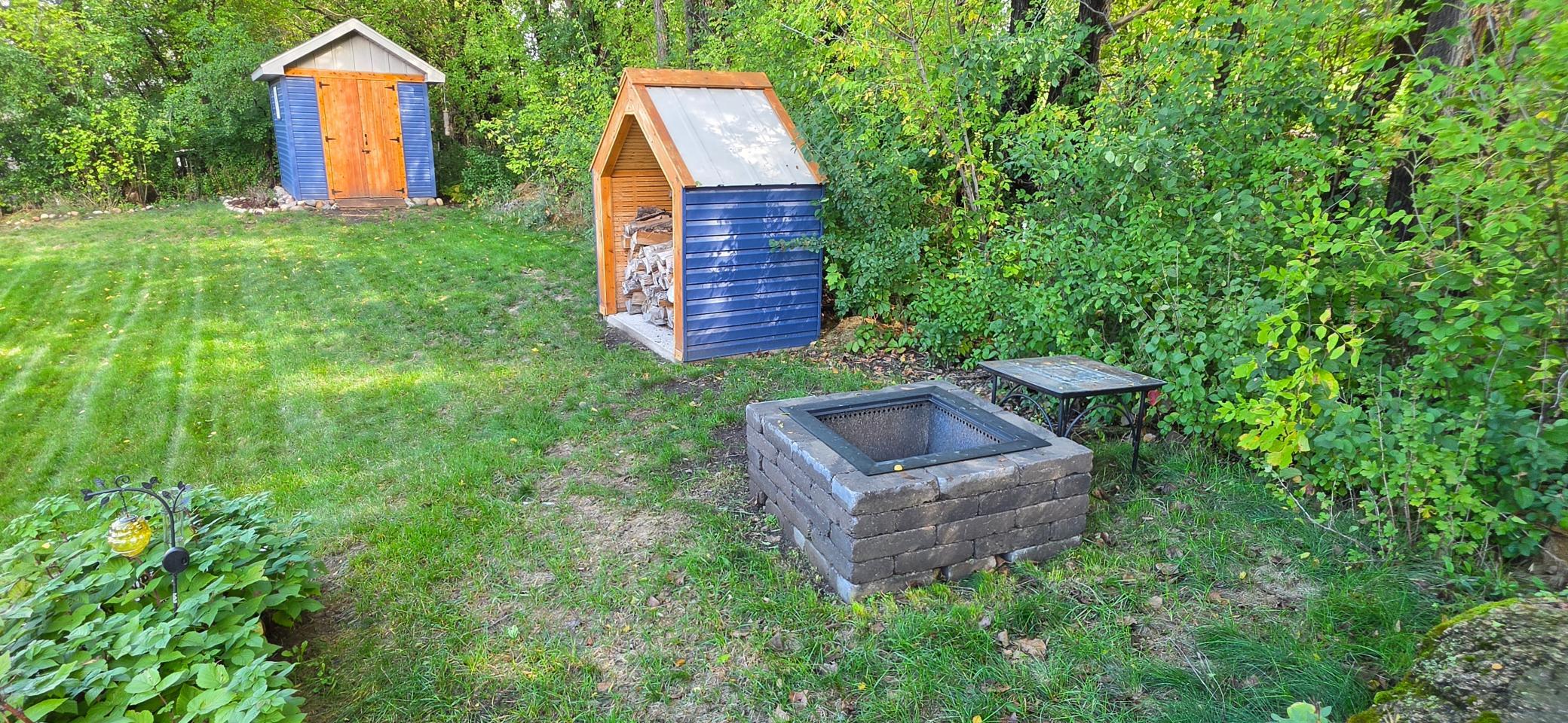 Smokeless fire pit in back along with a nice wood pile cover!