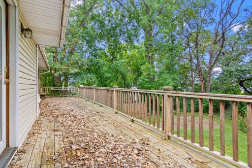 Massive deck spanning the entire rear of home.