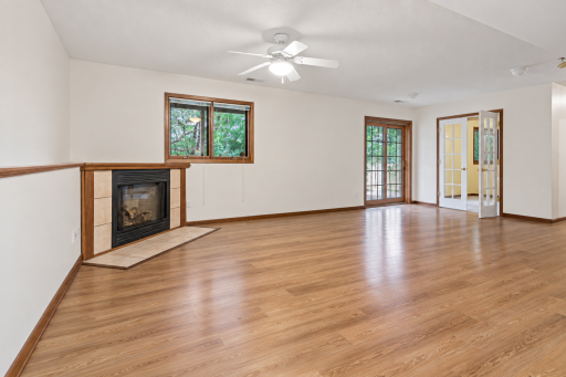 Lower level family room with walk out to patio. Virtually enhanced. Furniture and personal belongings removed.