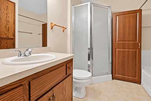 Main floor Full Bath with seperate tub/shower. Virtually enhanced. Furniture and personal belongings removed.