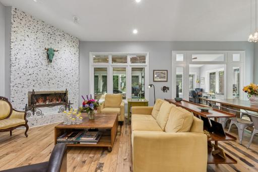 Sun-drenched living room with soaring ceilings and gorgeous natural light and cozy fireplace.