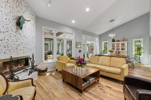 Vaulted ceilings and abundant windows create an airy, open feel in this inviting living space.