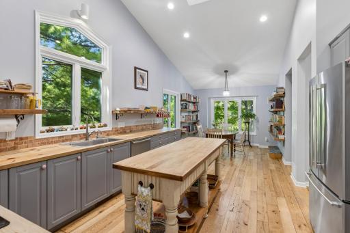 Spacious kitchen island with butcher block counters, perfect for meal prep.