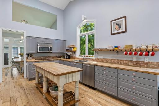 Sleek, updated kitchen with stainless appliances and a generous island â a chef's delight!
