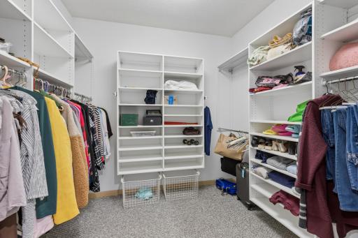 Walk in primary bedroom closet with built ins.